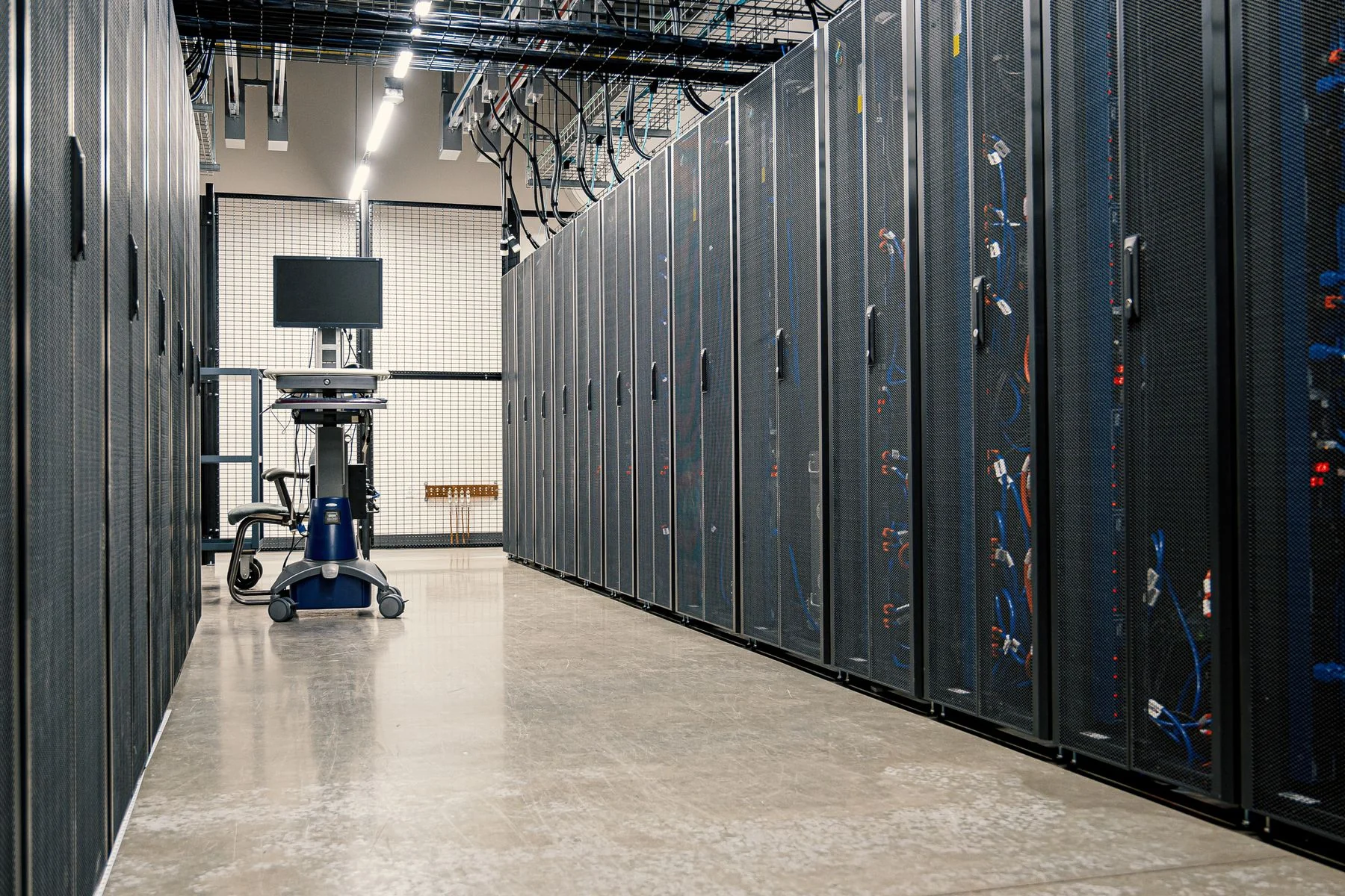 Data center corridor with enclosed server racks.